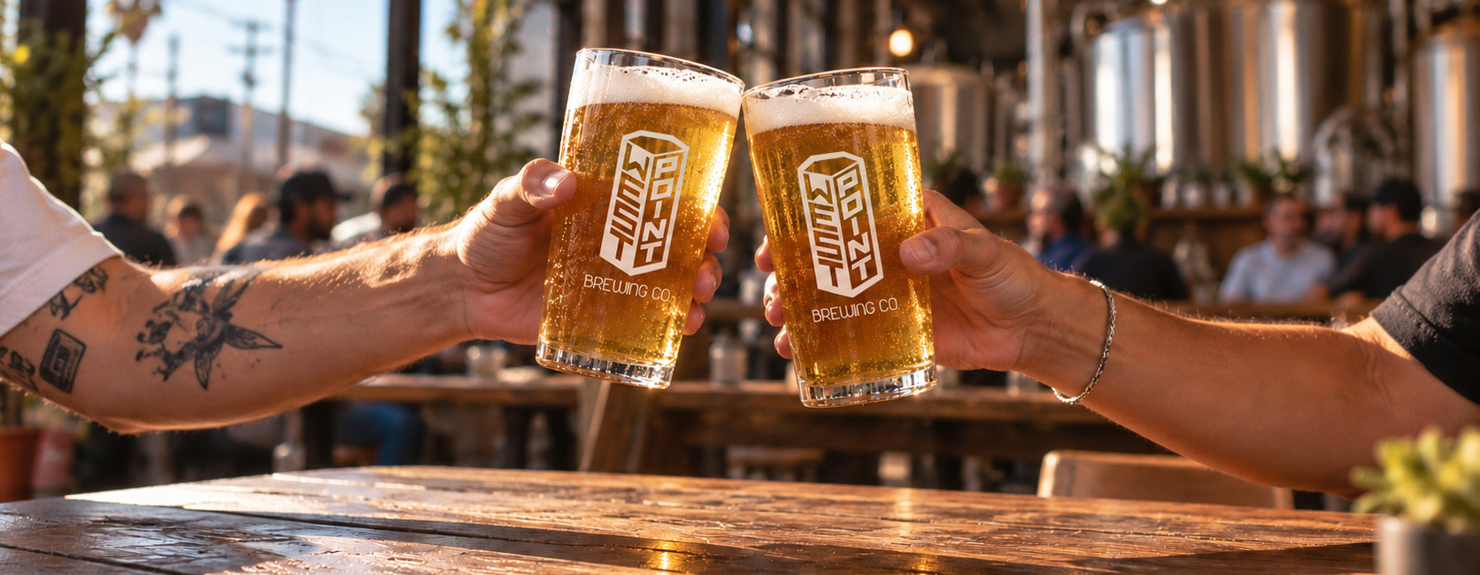 Two people cheering with West Point Brewing beers